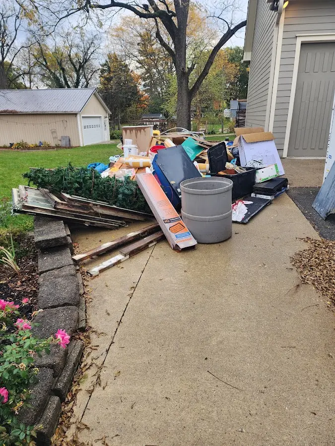 Dumpster being loaded with debris for Estate Cleanout Dumpster Rental in Morton Grove